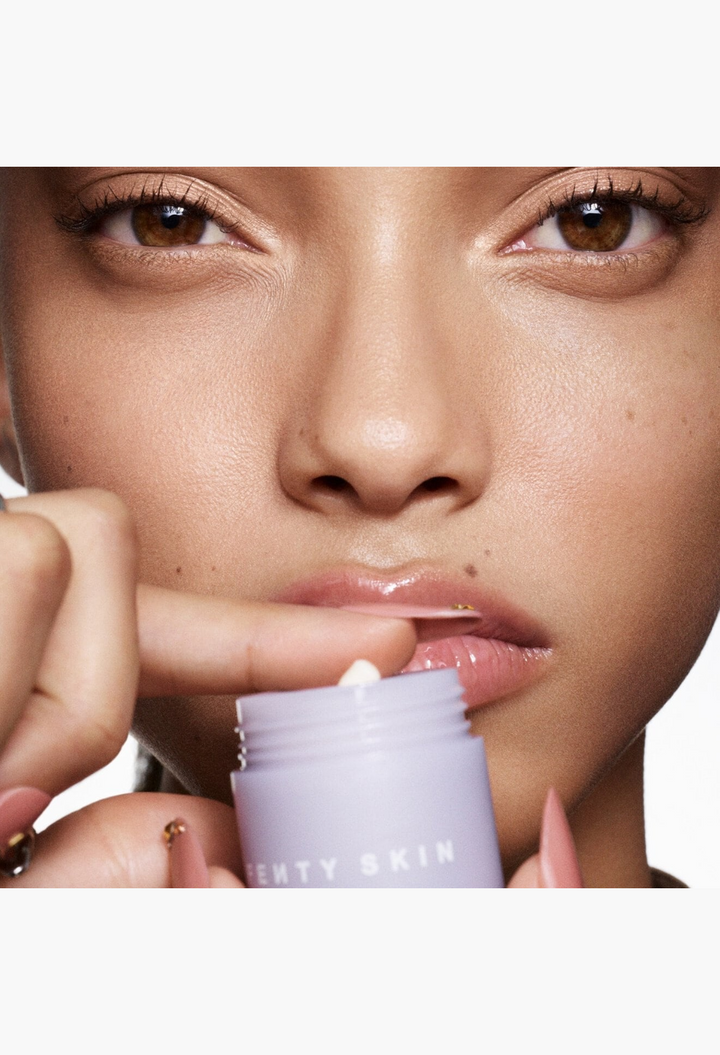 GLAM MODA Thicc N Smooth peptide eye cream applied under eyes on a model with a twist-up lavender pot