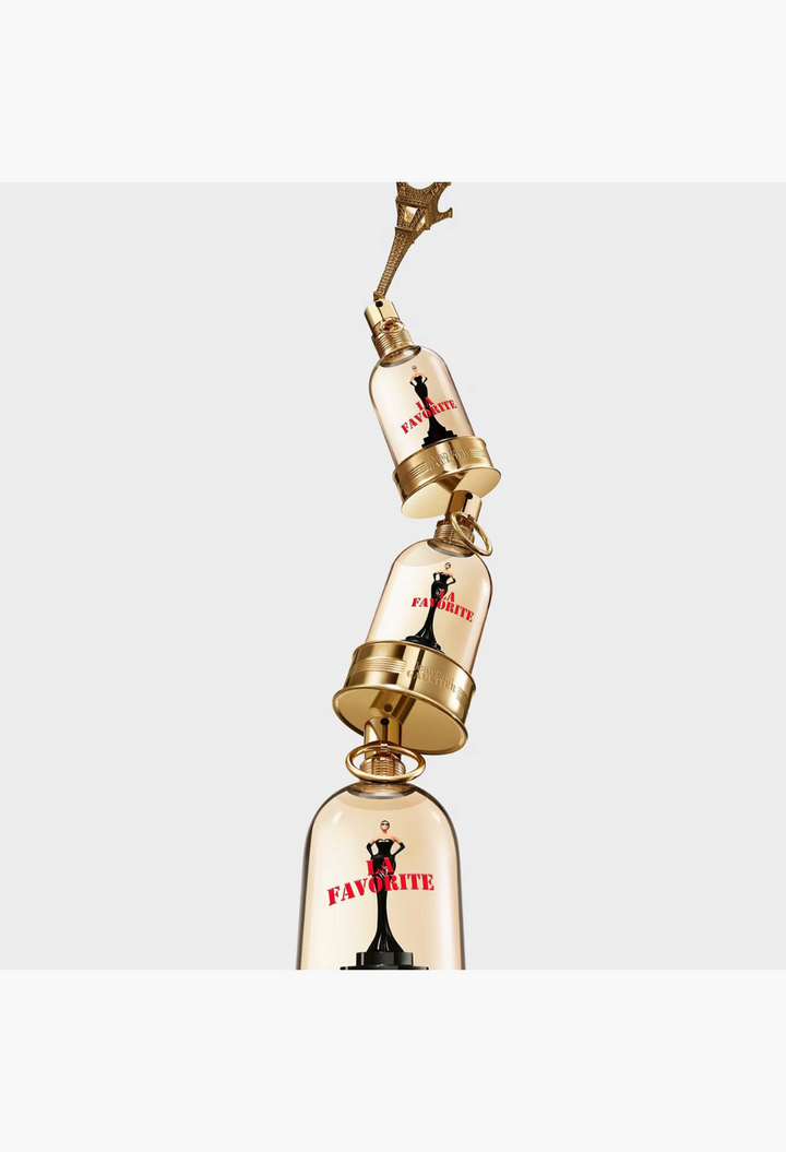 GLAM MODA Jean Paul Gaultier La Favorite Eau de Parfum bottles stacked vertically with a gold Eiffel Tower topper