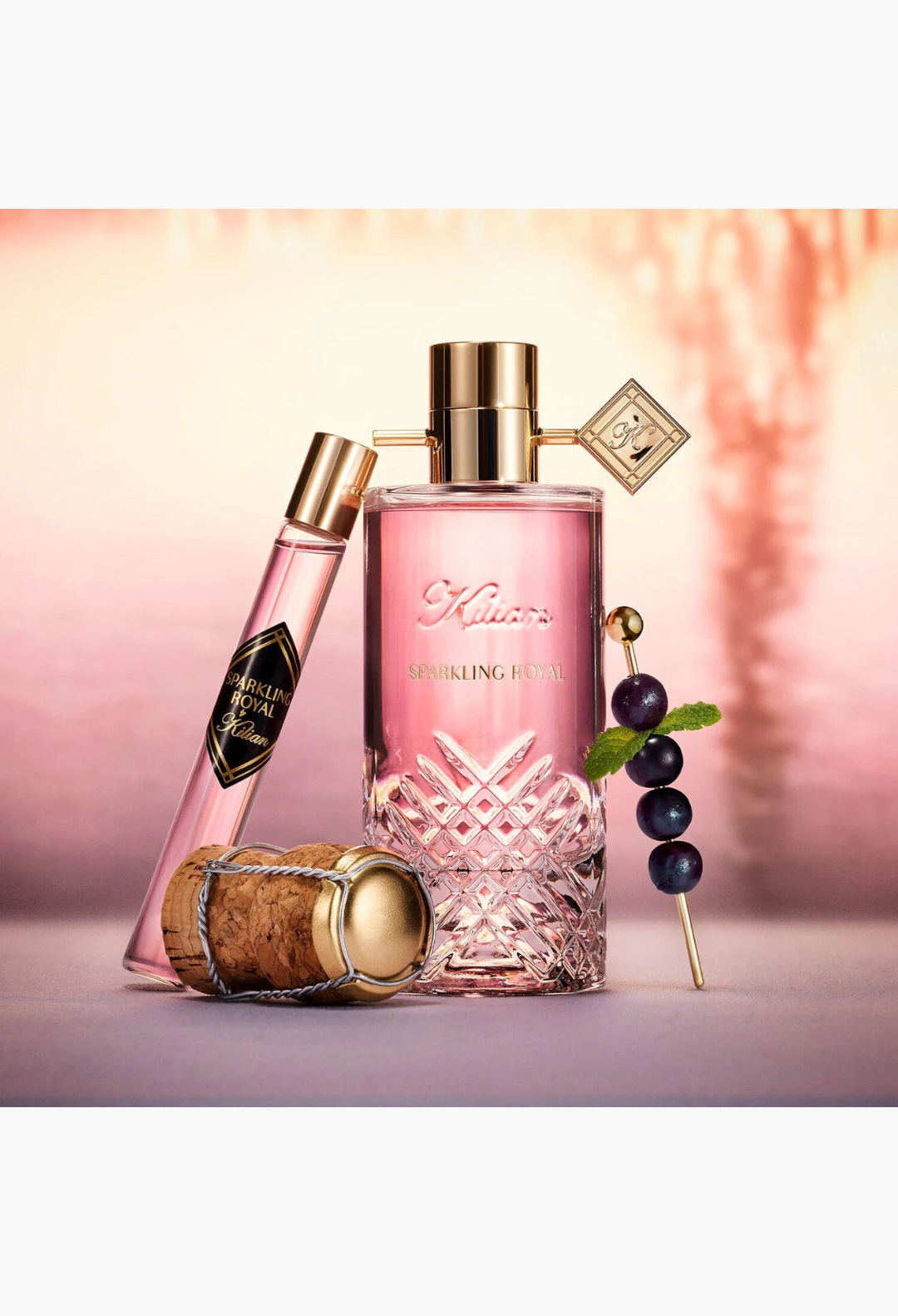 GLAM MODA Sparkling Royal Eau De Parfum bottle and travel spray with champagne cork and blackcurrant garnish
