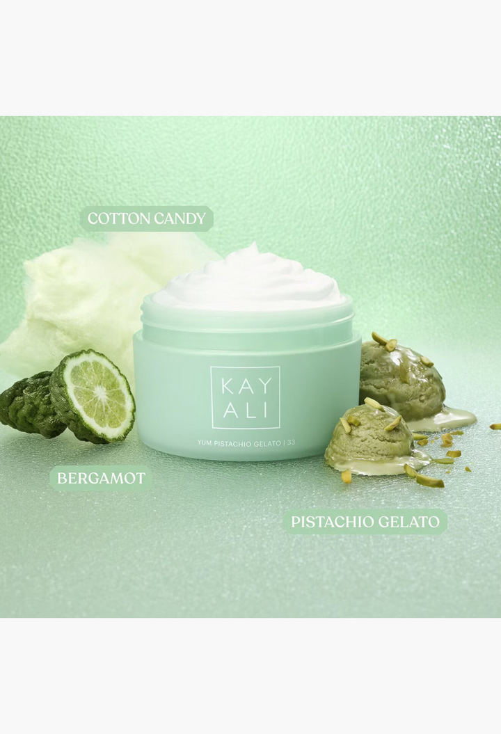 GLAM MODA KAYALI Yum Pistachio Gelato 33 body cream in a light green jar surrounded by cotton candy and pistachio gelato.