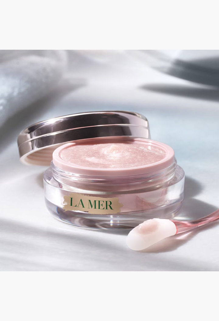 GLAM MODA The Lip Polish exfoliating balm in a glass jar with a metallic lid and a small applicator tool.