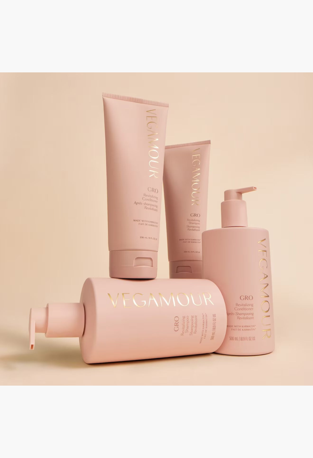 GLAM MODA collection of VEGAMOUR GRO revitalizing shampoo and conditioner bottles in soft pink packaging.