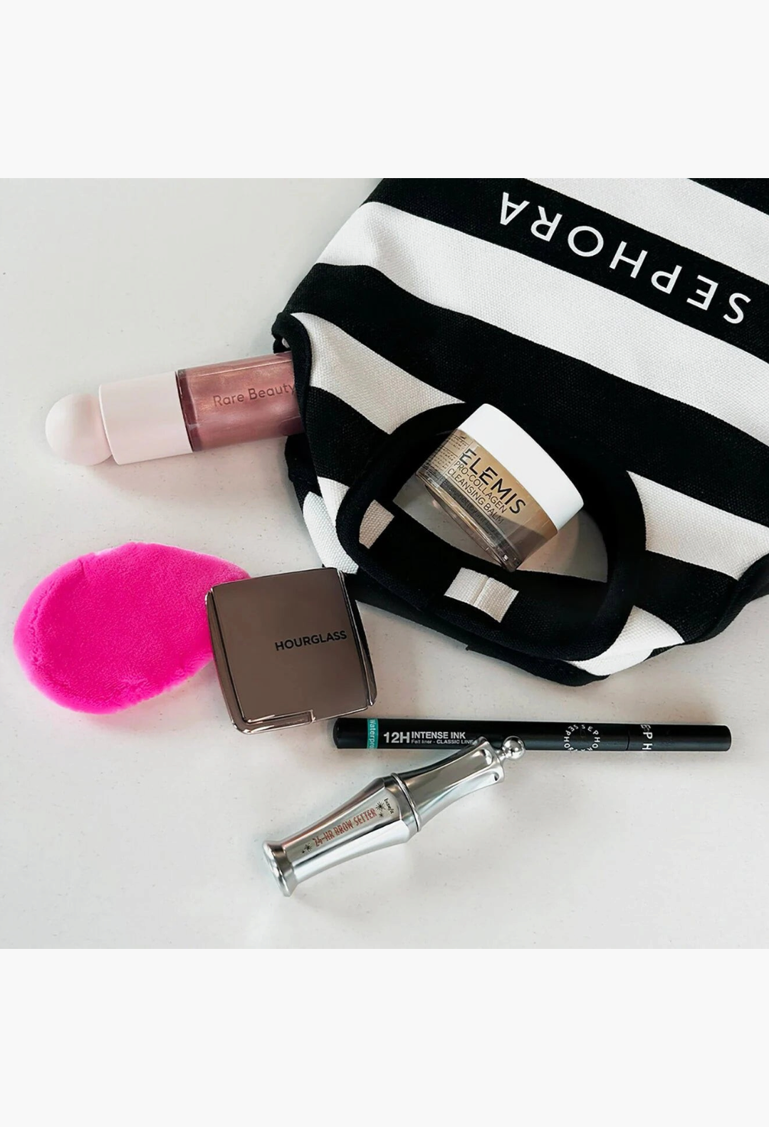 GLAM MODA Glitz & Glam beauty set featuring Sephora makeup, Elemis balm, and Beauty Blender in a striped pouch.