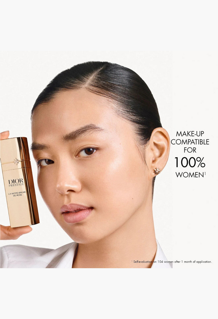 GLAM MODA model holding a gold Dior Prestige La Micro-Brume de Rose revitalizing face mist bottle