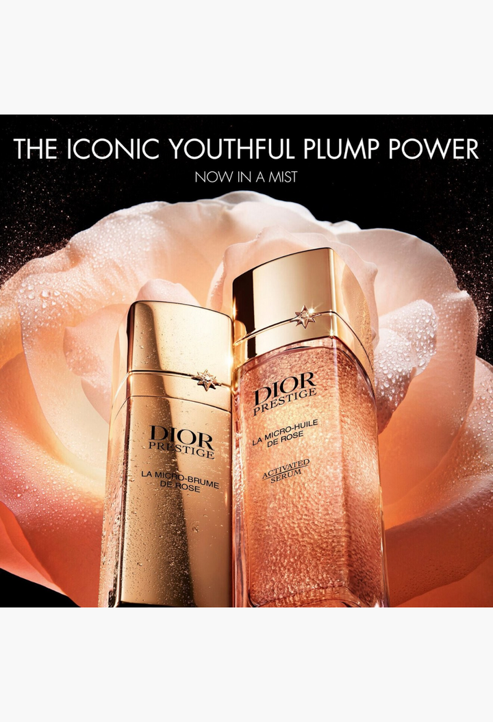 GLAM MODA Dior Prestige La Micro-Brume de Rose mist and serum bottles displayed against a soft pink rose petal