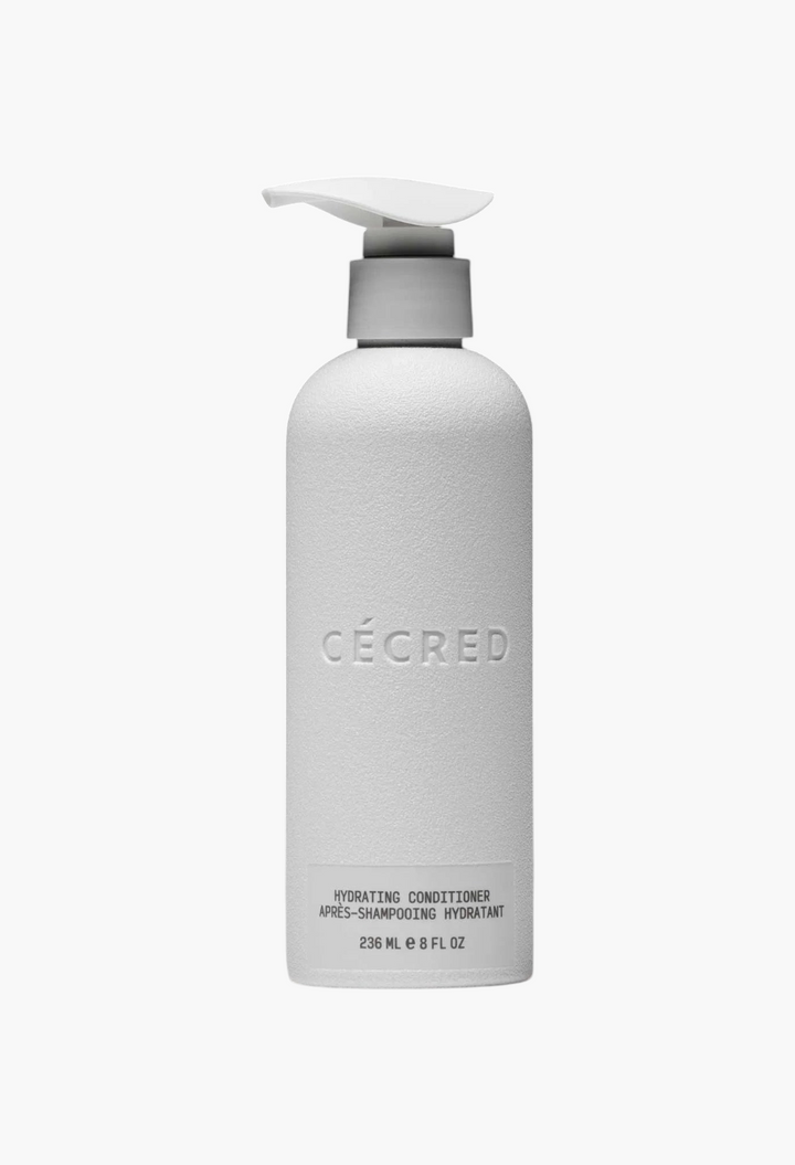 GLAM MODA Cécred Hydrating Conditioner in a white pump bottle against a black background
