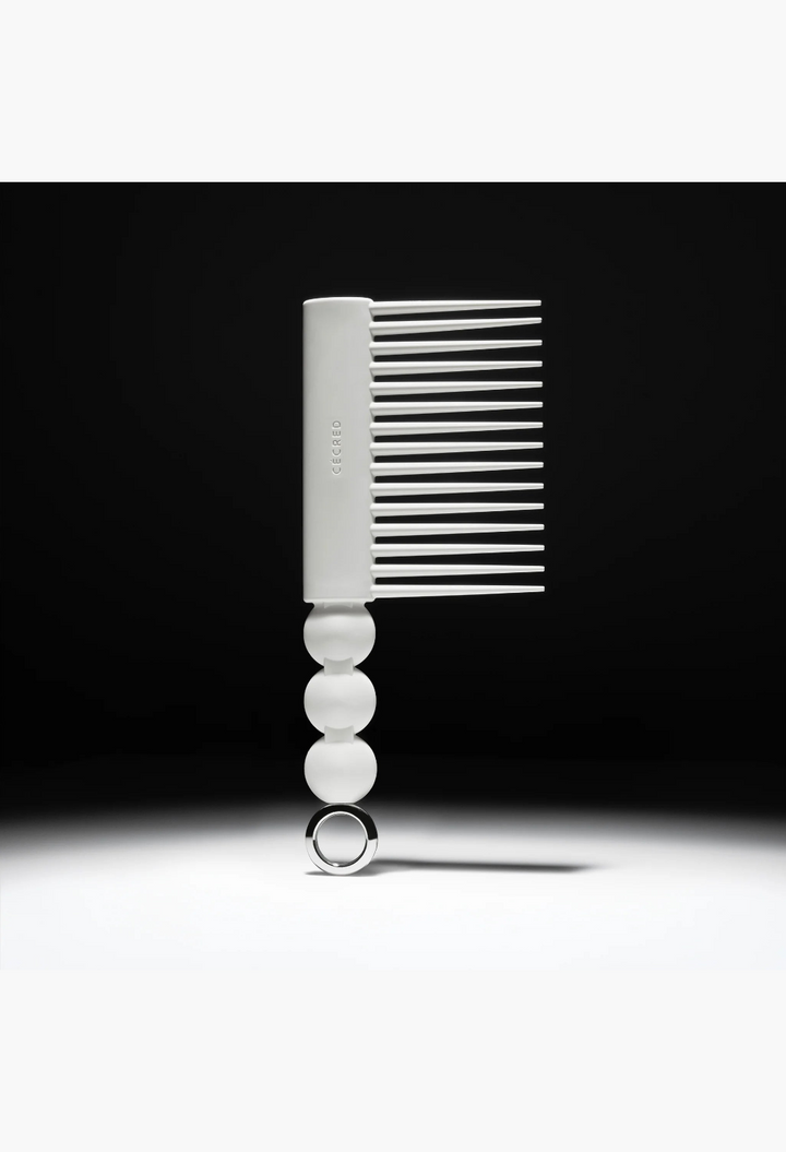 GLAM MODA Rake Comb in matte white with long tapered teeth and a decorative spherical handle with a metal ring.