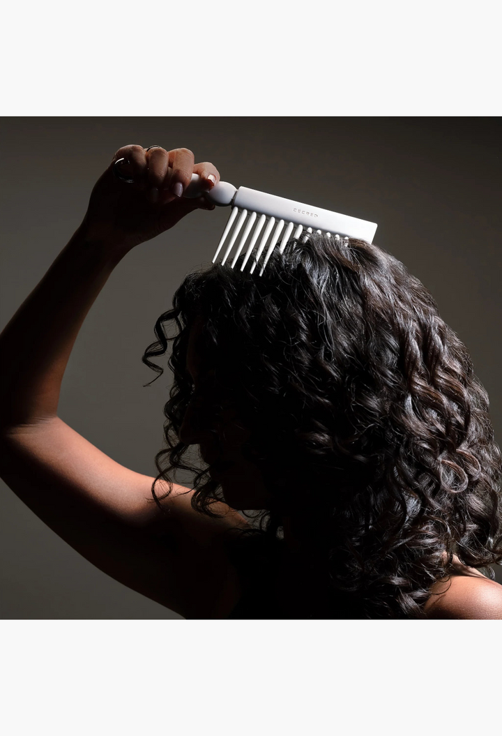 GLAM MODA Rake Comb with long tapered teeth being used to detangle curly hair for added volume