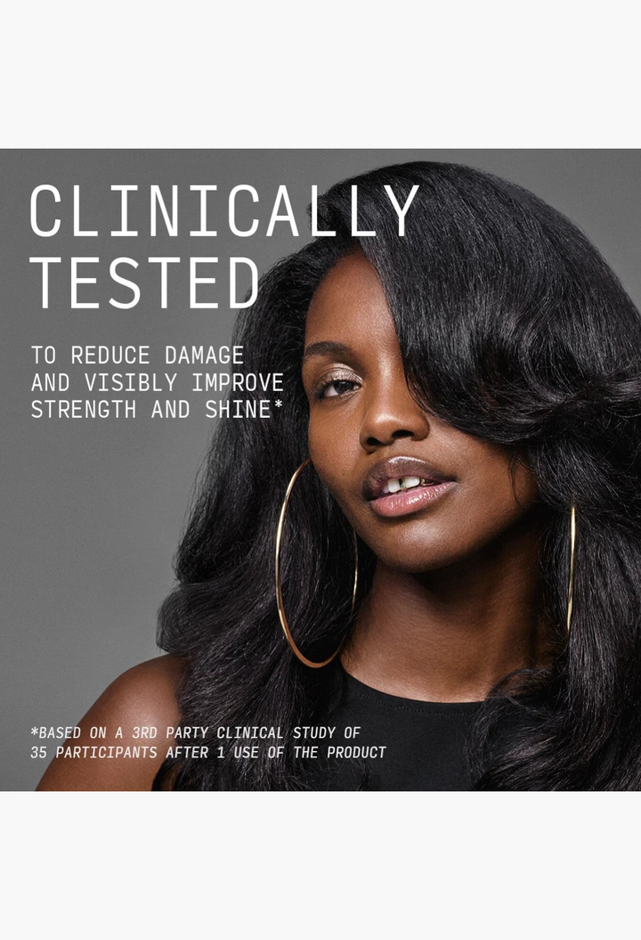 GLAM MODA Reconstructing Treatment Mask model with healthy, shiny dark hair and gold hoop earrings