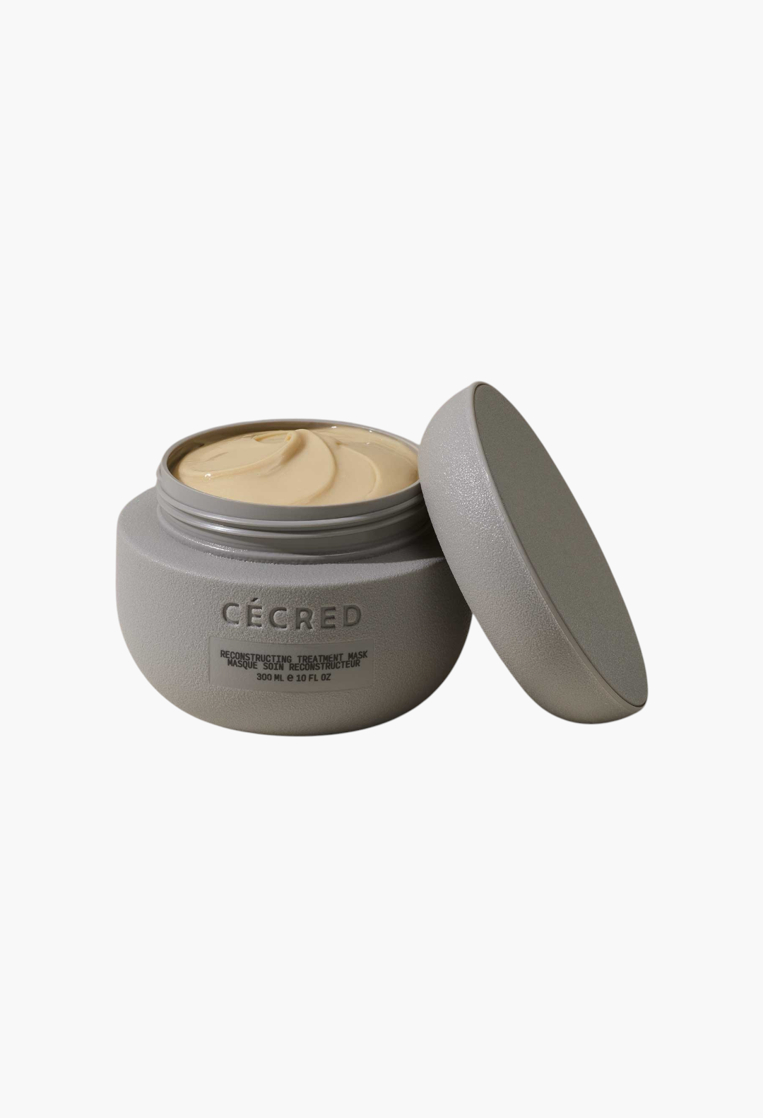 GLAM MODA Cécred Reconstructing Treatment Mask in a grey jar with a creamy beige hair repair formula inside.