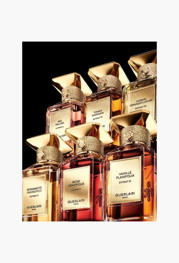 GLAM MODA collection of Guerlain L'Art & La Matière perfume extract bottles with gold caps and elegant glass labels