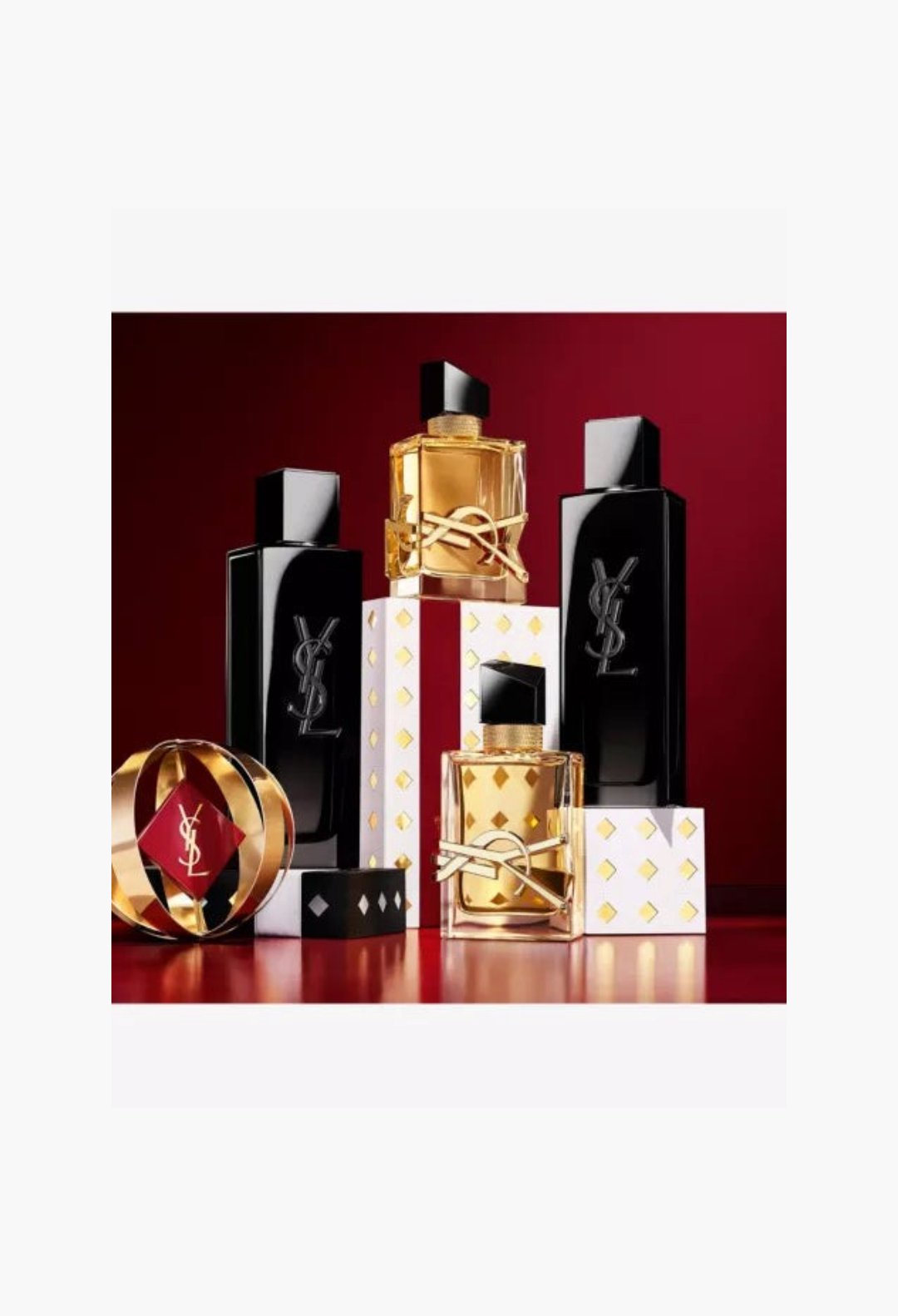 GLAM MODA Yves Saint Laurent 2026 advent calendar featuring luxury perfume bottles and gold accents on a red background