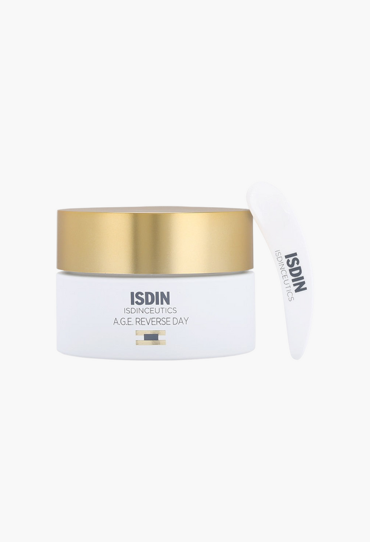GLAM MODA Isdinceutics A.G.E. Reverse Day Cream in a white jar with a gold lid and a white application spatula