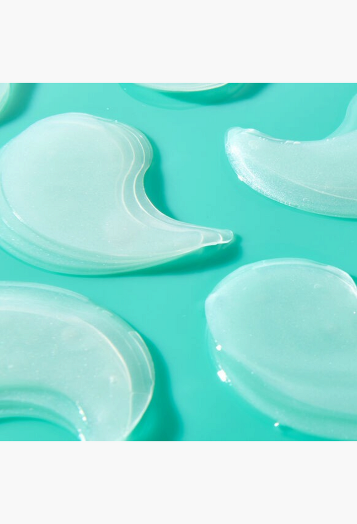 GLAM MODA Patchology FlashPatch rejuvenating hydrogel eye masks with a cooling translucent texture on a teal background