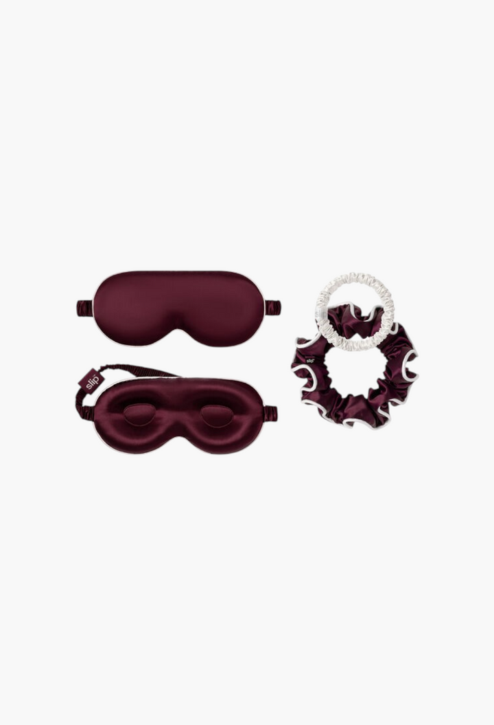 GLAM MODA Slip Pure Silk Beauty Sleepover Set in crimson and white featuring a contour sleep mask and silk scrunchies.