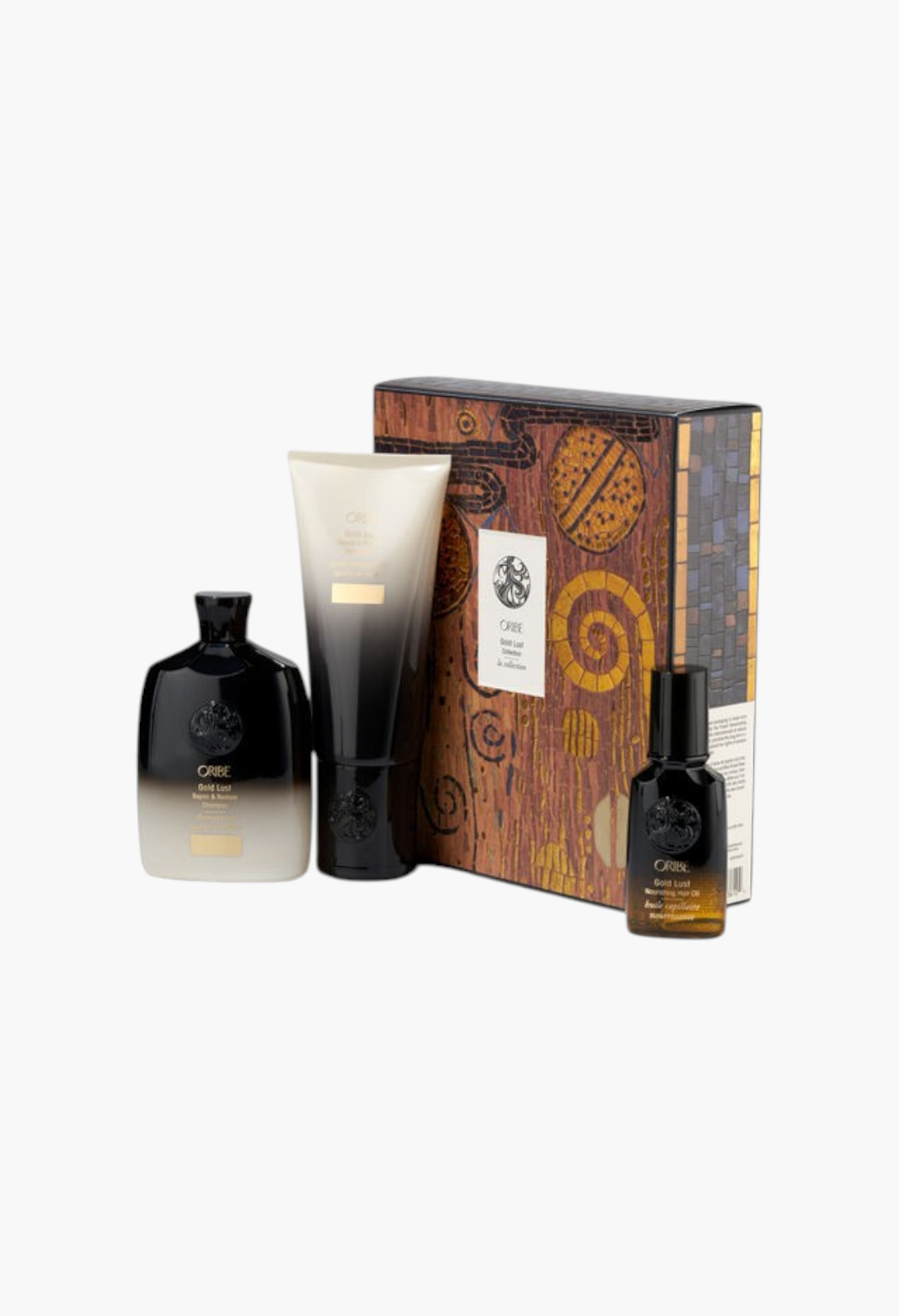 GLAM MODA Oribe Gold Lust haircare set featuring shampoo, conditioner, and nourishing hair oil in a decorative box.