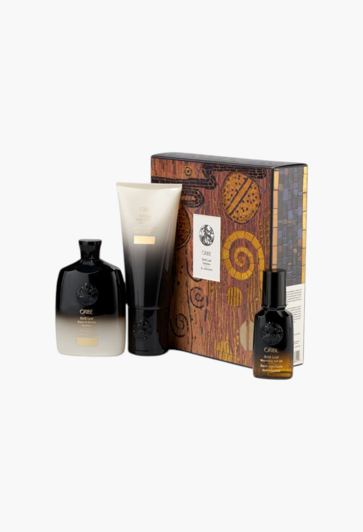 GLAM MODA Oribe Gold Lust haircare set featuring shampoo, conditioner, and nourishing hair oil in a decorative box.