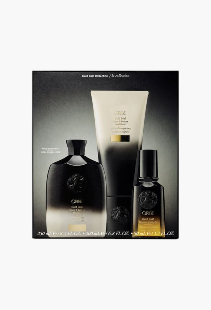 GLAM MODA Oribe Gold Lust haircare gift set featuring shampoo, conditioner, and nourishing hair oil in black bottles.