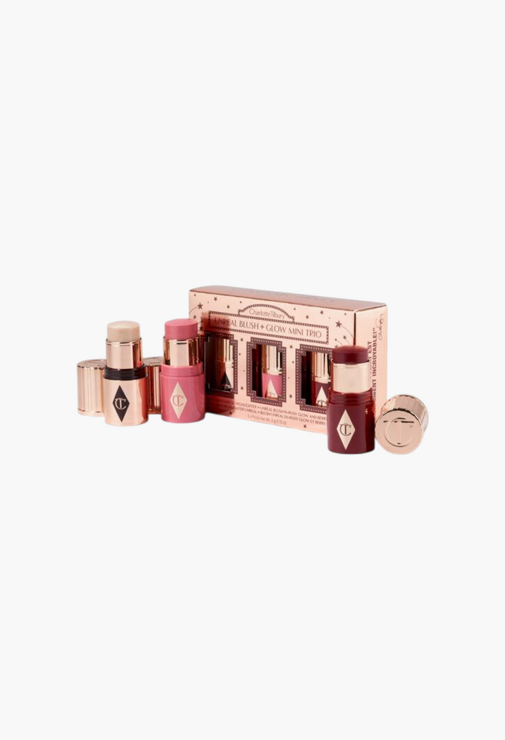 GLAM MODA Charlotte Tilbury Unreal Blush + Glow Mini Trio featuring three travel-sized blush and highlighter sticks.