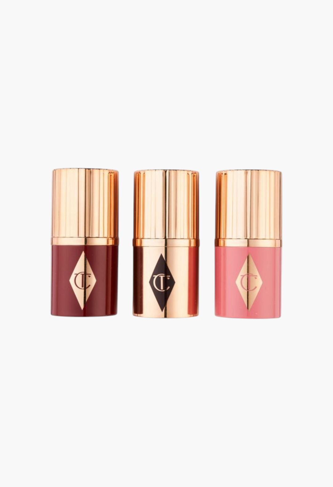 GLAM MODA Charlotte Tilbury Unreal Blush and Glow mini trio featuring berry, rosy, and champagne highlighter sticks.