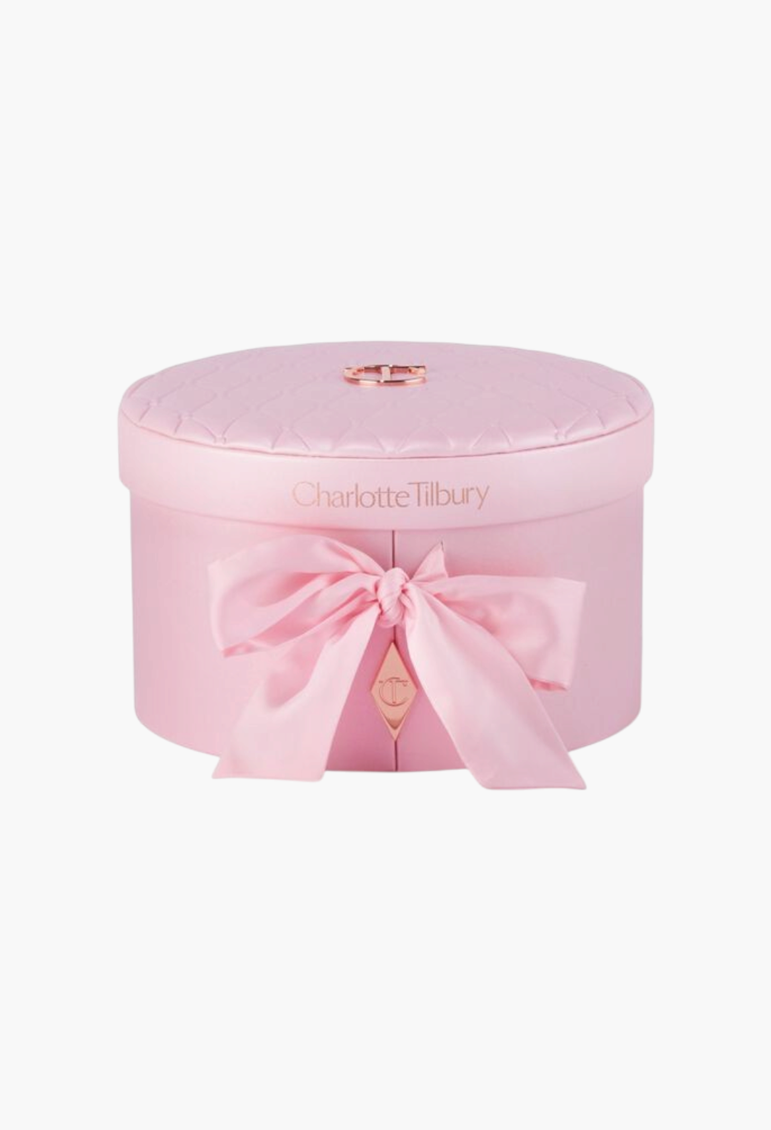 GLAM MODA Charlotte Tilbury Pillow Talk Dreams Come True vanity box in a round, quilted pink case with a satin bow.