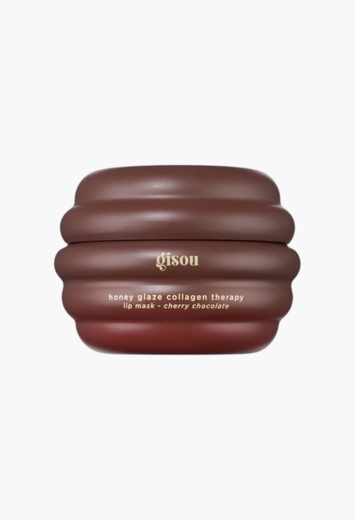 GLAM MODA Gisou Cherry Chocolate lip mask in a brown, beehive-shaped jar with gold text.