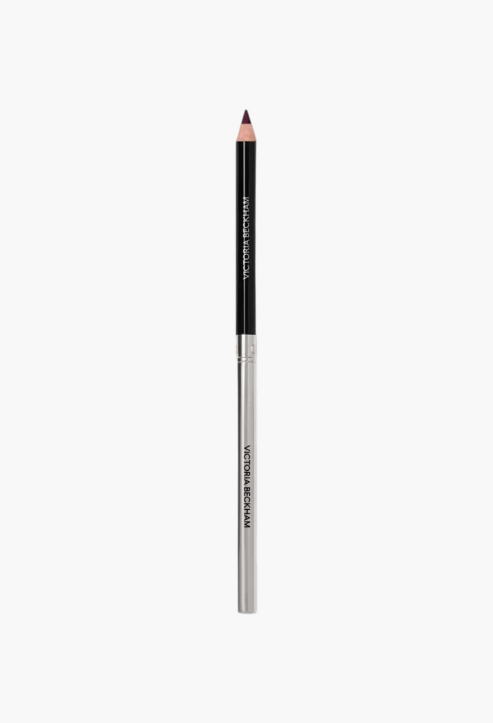 GLAM MODA Victoria Beckham Beauty Lip Definer pencil in a dark plum shade with a sleek black and silver casing.