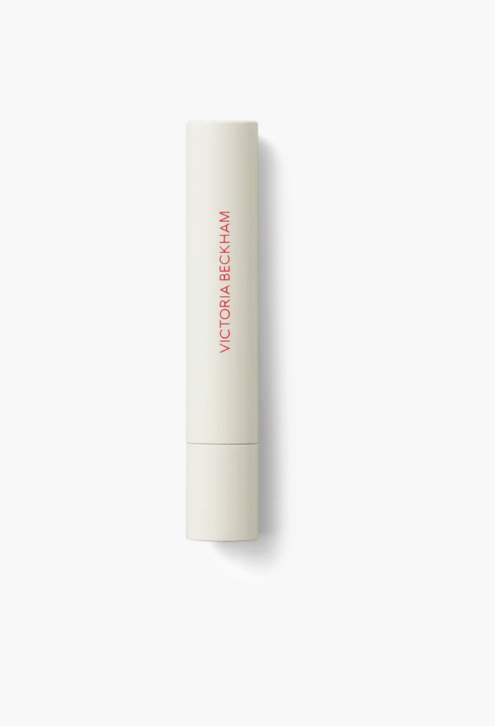 GLAM MODA Posh Balm Nourishing Lip Shine in a sleek, slim beige twist-up tube with red branding.