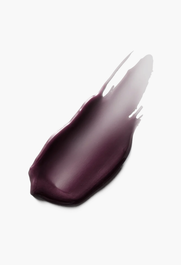 GLAM MODA Posh Balm Nourishing Lip Shine swatch in a deep berry purple shade with a glossy, melty texture.