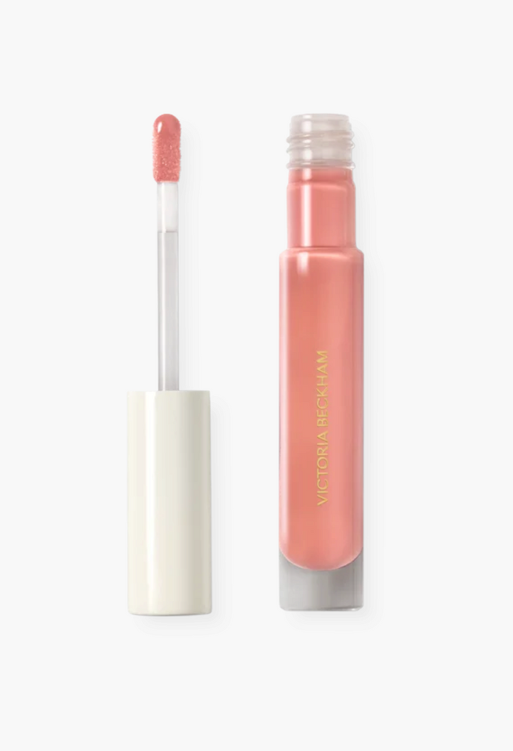 GLAM MODA Posh Gloss high shine lip gloss in a soft peach shade with a doe foot applicator and sleek tube packaging.