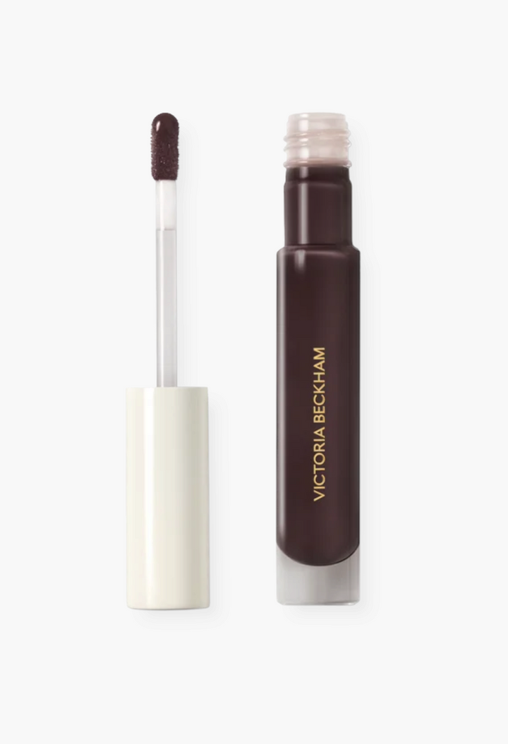 GLAM MODA Posh Gloss in a deep brown shade with a doe foot applicator and sleek, minimalist packaging.