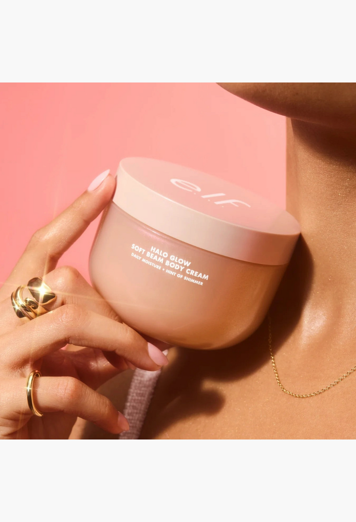 GLAM MODA Halo Glow Soft Beam body cream jar held against skin for a radiant, shimmering, and moisturized finish.