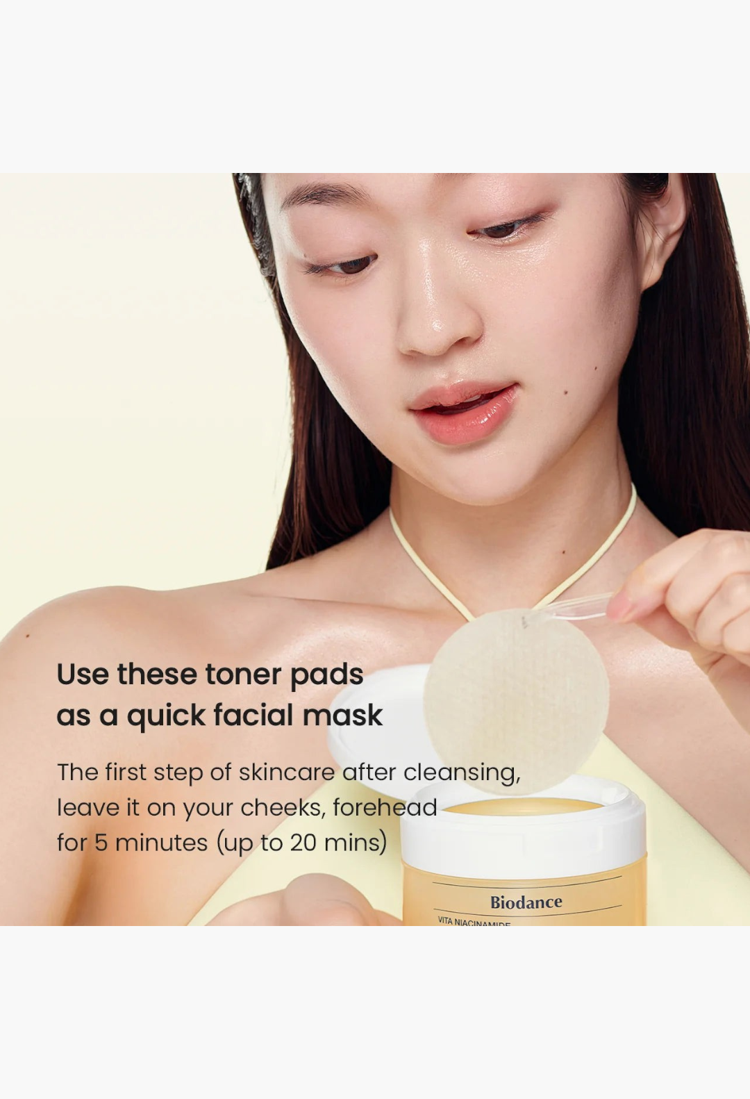 GLAM MODA model applying a round Vita Niacinamide gel toner pad to her cheek as a quick facial mask for glowing skin