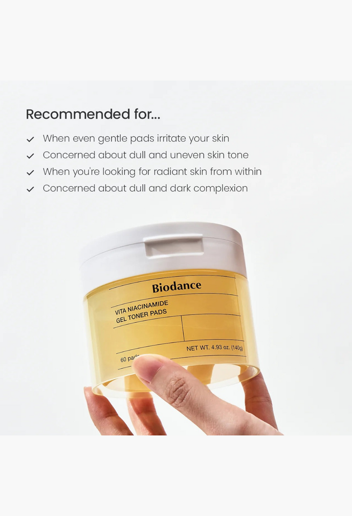 GLAM MODA Biodance Vita Niacinamide Gel Toner Pads in a yellow translucent jar held by a hand