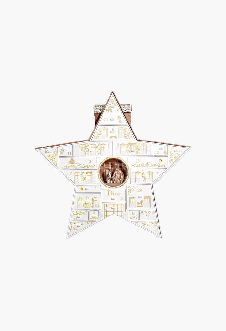 GLAM MODA Le 30 Montaigne Dior star-shaped advent calendar with 24 numbered drawers and a central holiday scene.