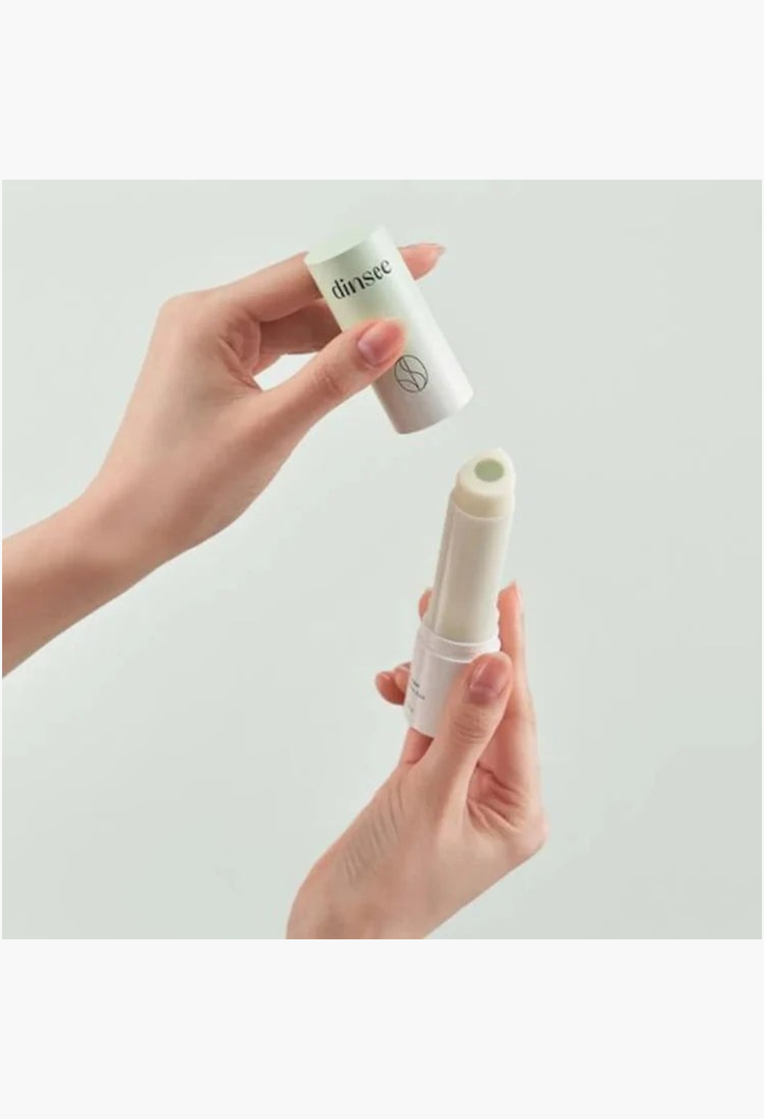 GLAM MODA Dinsee vegan 3-in-1 sunscreen stick with SPF50+ PA++++ being opened by hands for easy daily application.