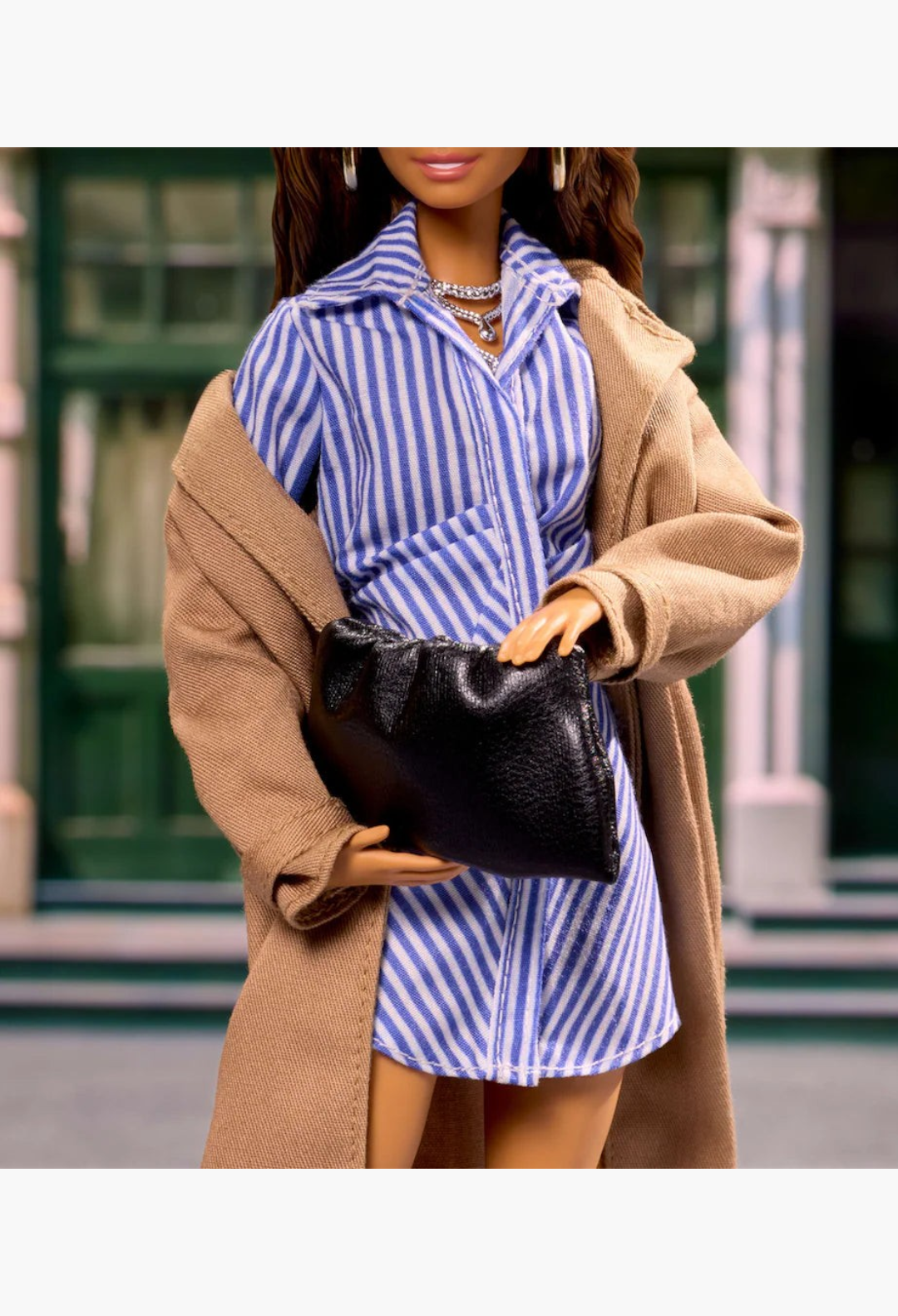 GLAM MODA New York Fashion Week Barbie doll wearing a blue striped shirt dress, tan coat, and holding a black clutch.