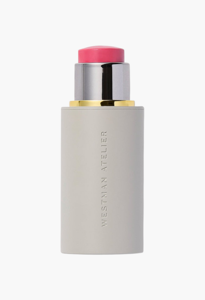 GLAM MODA Westman Atelier Baby Cheeks Blush Stick in a vibrant pink shade with a sleek grey twist-up applicator.
