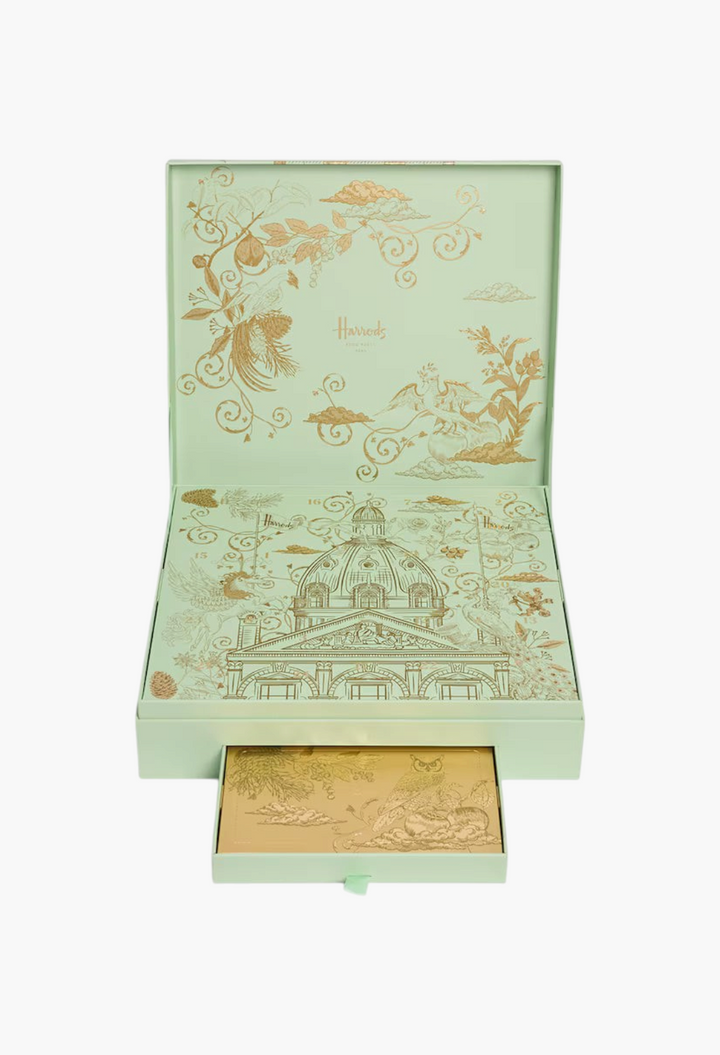 GLAM MODA Chocolaterie Advent Calendar in a light green box with gold foil illustrations of the Harrods building.