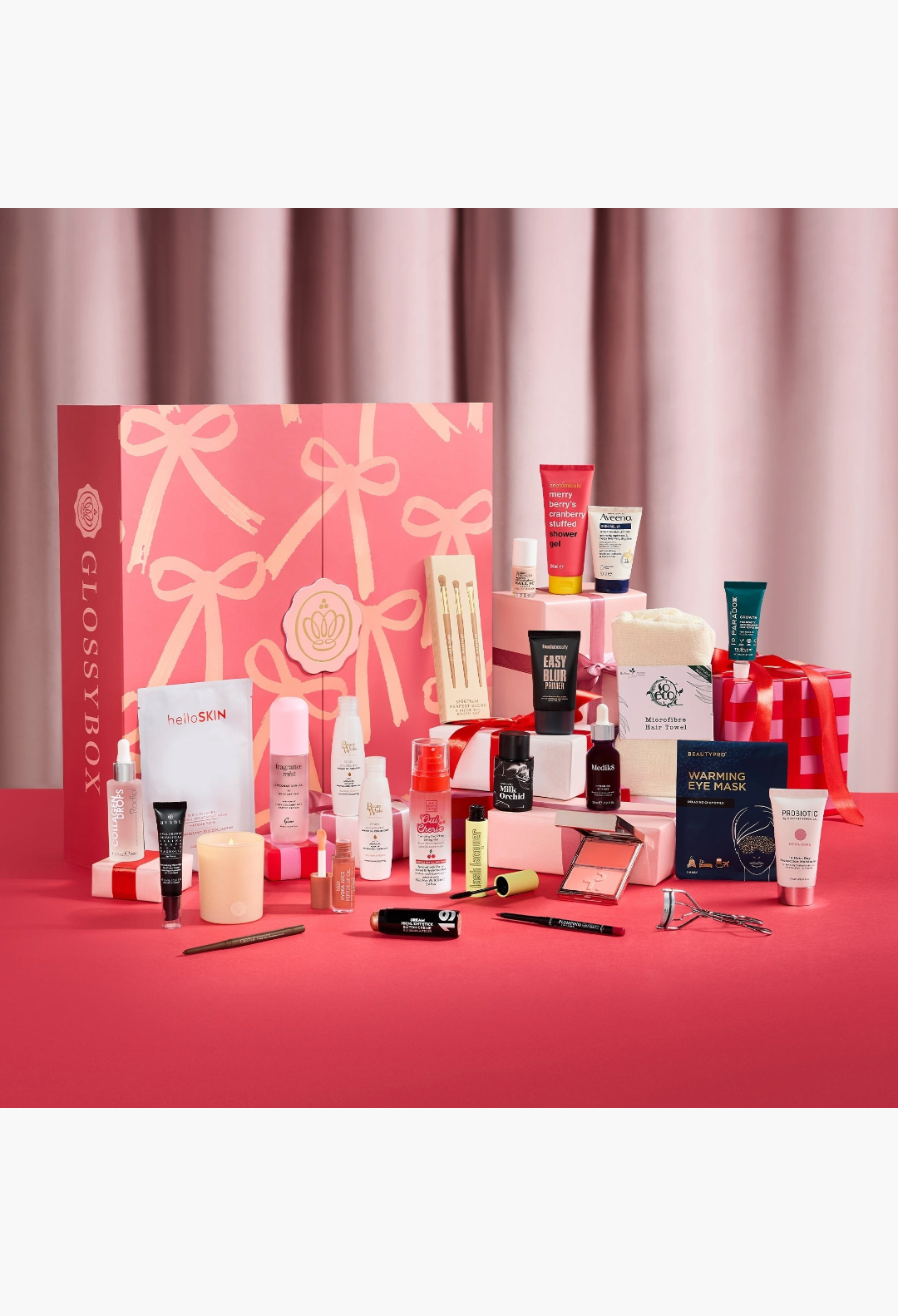 GLAM MODA GLOSSYBOX 2026 Advent Calendar in pink with bow design, surrounded by various beauty and skincare products.