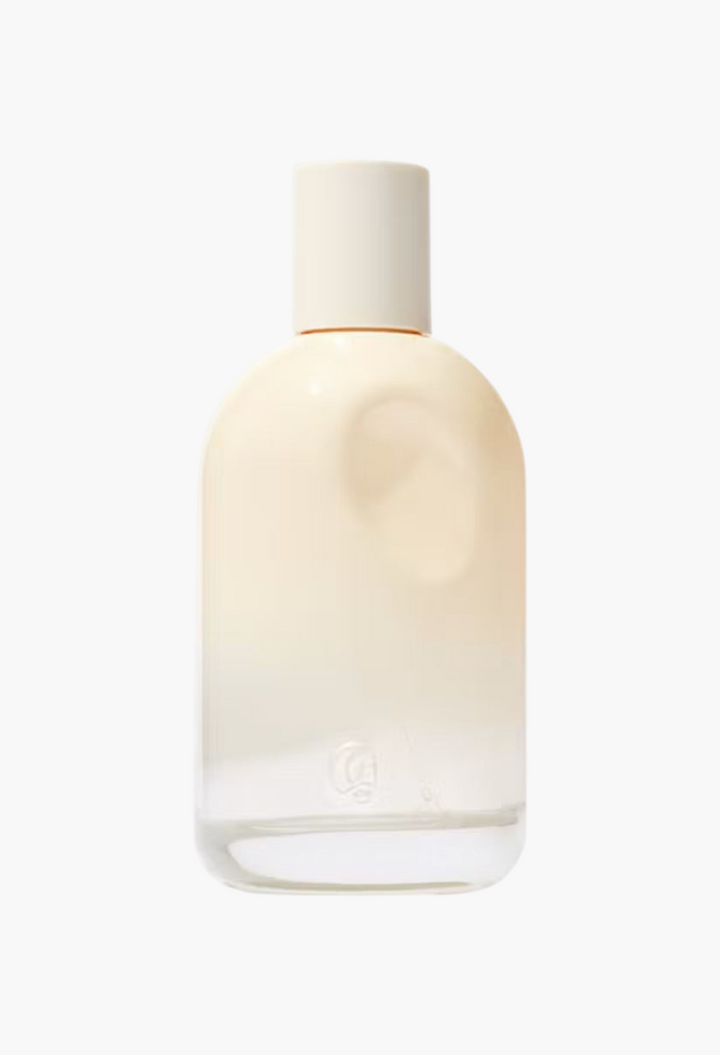 GLAM MODA Glossier You Doux eau de parfum in a minimalist glass bottle with a soft cream-colored gradient finish.