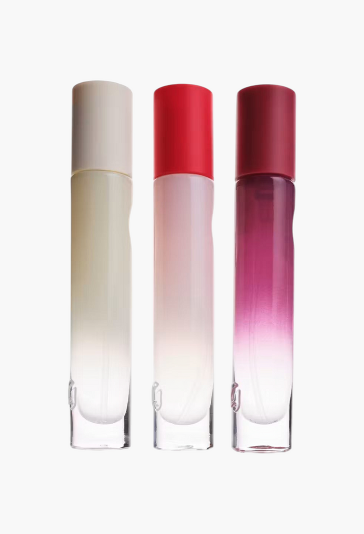 GLAM MODA Glossier You Doux eau de parfum collection featuring three sleek glass spray bottles with colored caps.
