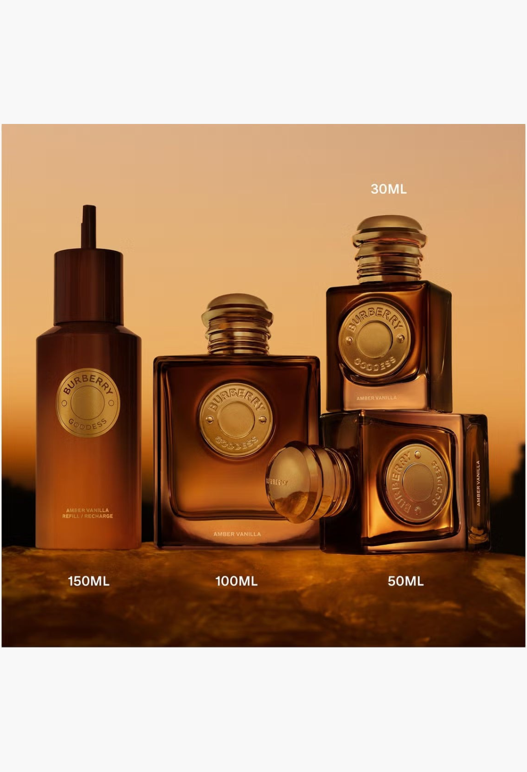 GLAM MODA collection of Burberry Goddess Amber Vanilla perfume bottles with golden caps and amber glass design.