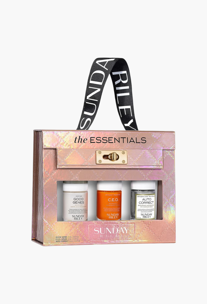 GLAM MODA Sunday Riley The Essentials skincare kit featuring three 15ml bottles in a metallic pink gift box.