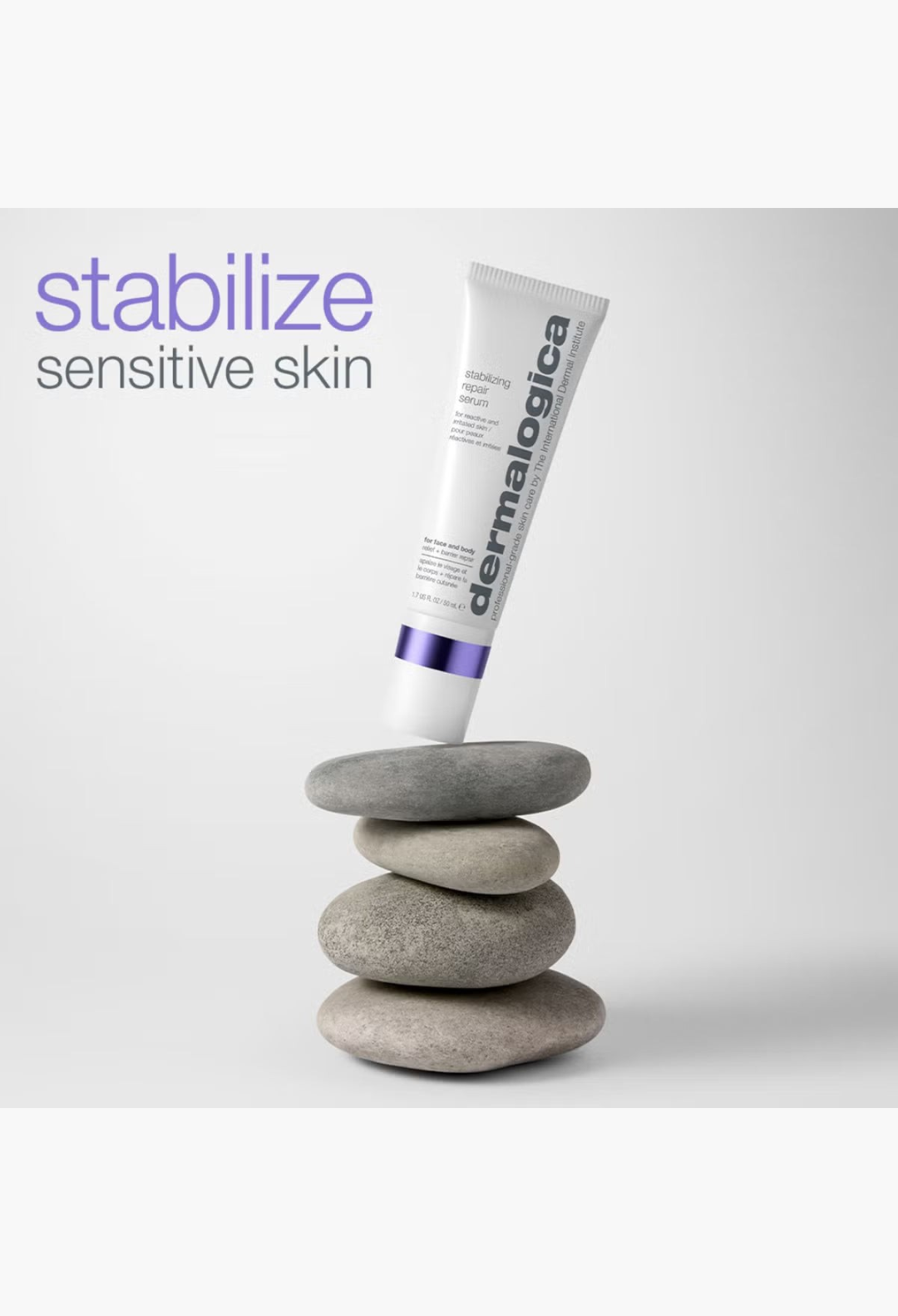 GLAM MODA Dermalogica Stabilizing Repair Serum tube balanced on a stack of smooth grey river stones