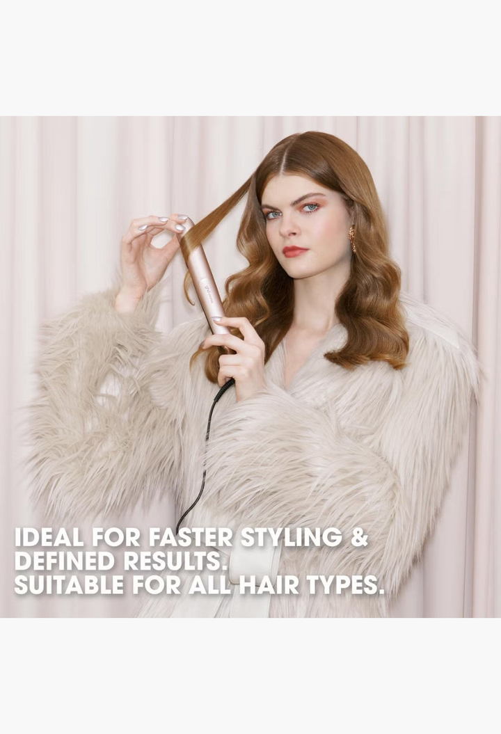 GLAM MODA model styling her wavy hair with the ghd Chronos Styler, featuring a sleek metallic finish.