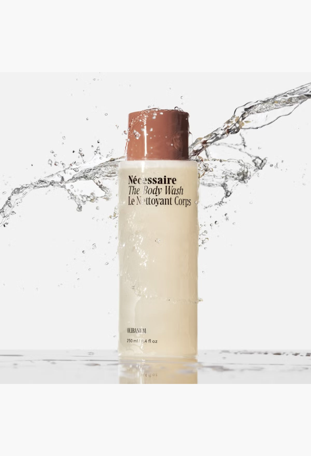 GLAM MODA Nécessaire The Body Wash Olibanum in a minimalist bottle surrounded by a refreshing water splash