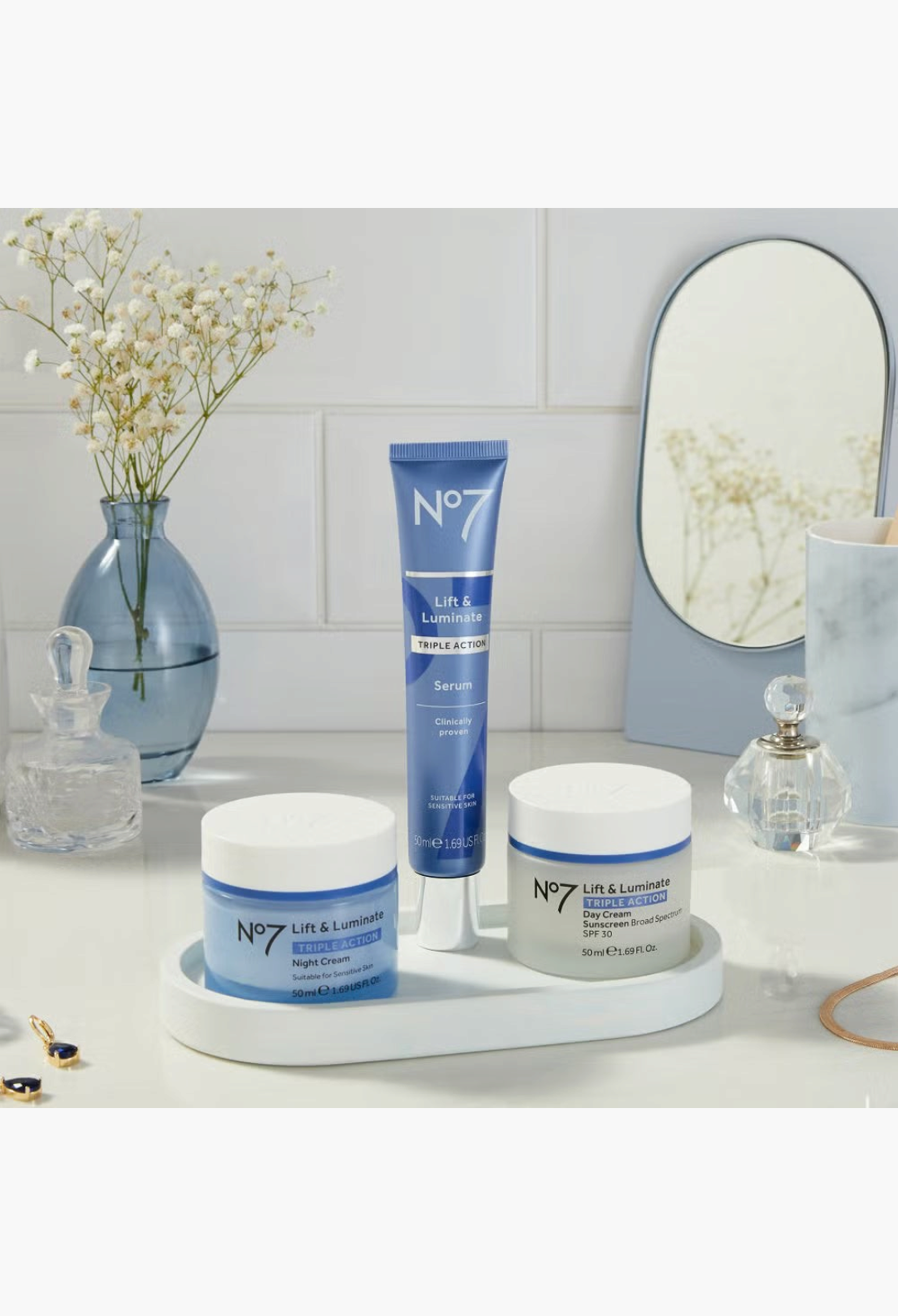 GLAM MODA No7 Lift & Luminate 3-piece skincare set featuring serum, day cream with SPF 30, and night cream on a tray.