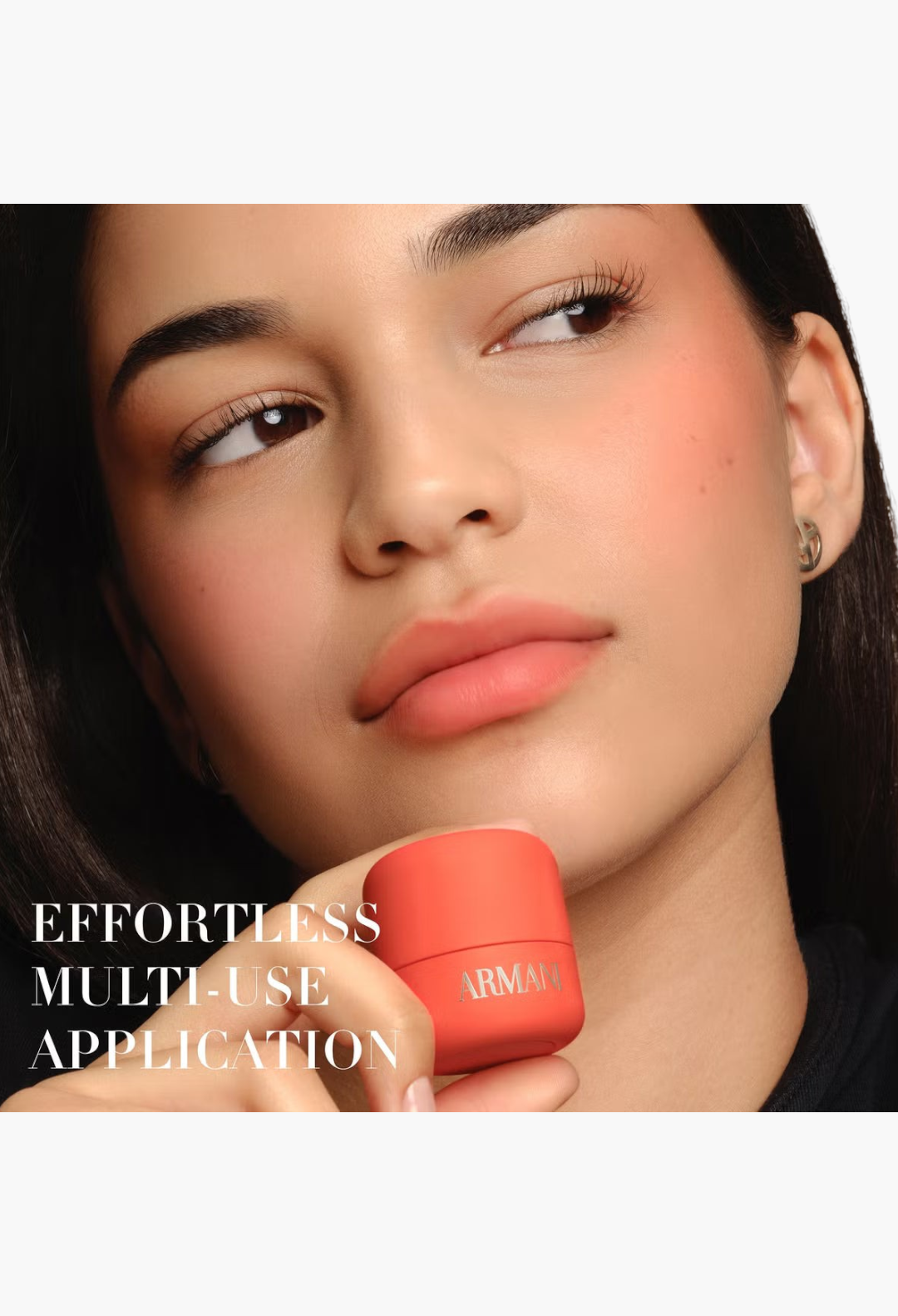 GLAM MODA model applying Armani Beauty Dolci Blush in a soft coral shade to cheeks and lips for a radiant finish.