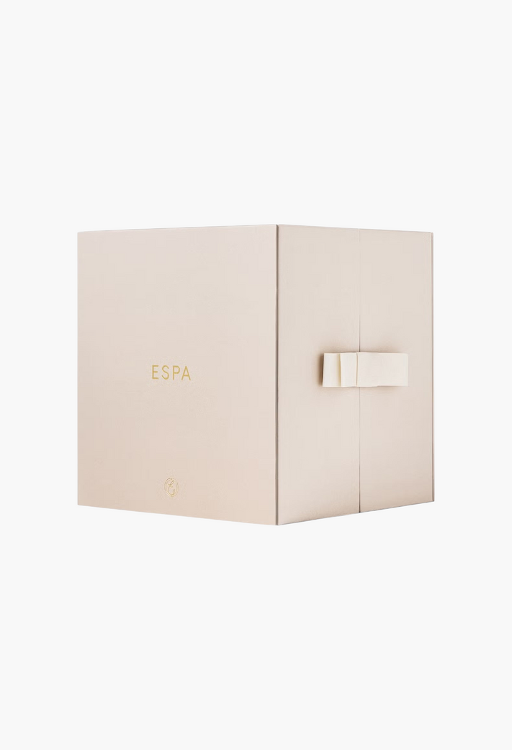 GLAM MODA ESPA Moments of Wellness Advent Calendar in a minimalist beige gift box with a ribbon closure.